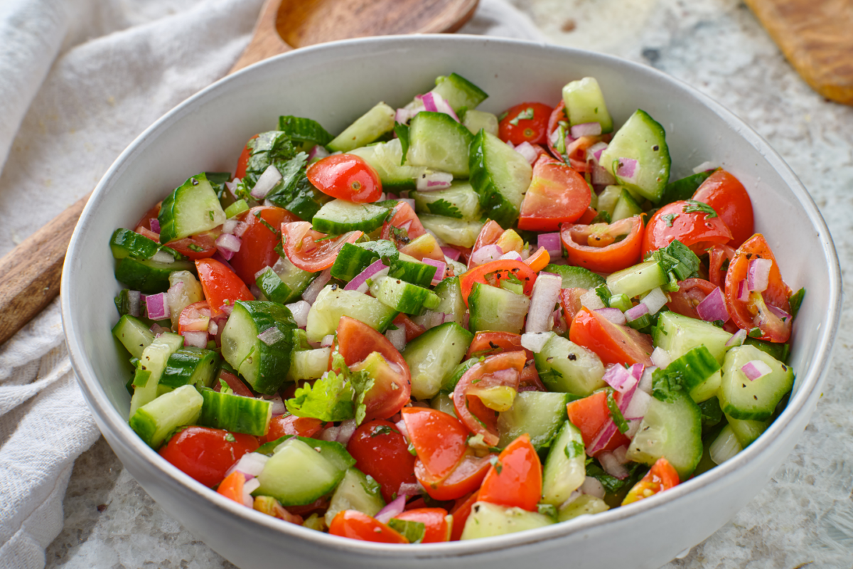 A bowl of chopped tomato and cucumber salad